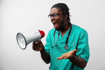 Young black doctor in green uniform using speaker.