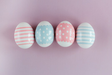 Easter eggs in pastel colors with a pattern on a pink background.