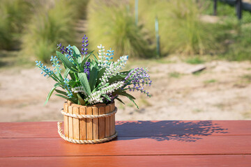 Beautiful flowers basket on wood table