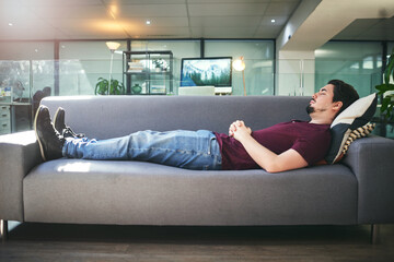 The subconscious holds the answers to lifes questions. Shot of a young man lying down on a sofa in...