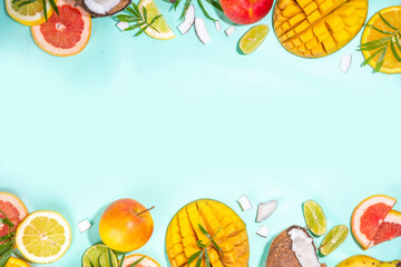 Summer fruits background. Various tropical fruits on turquoise background - mango, coconut, apples, avocado, lemon, orange, grapefruit, pineapple, with palm leaves. Colorful frame, banner flatlay