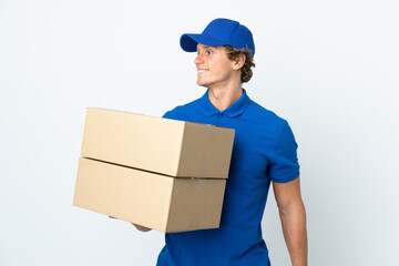 Delivery man over isolated white background looking to the side and smiling