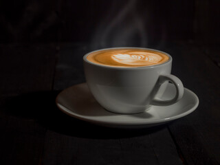 Coffee Mug on Wooden Table. Cup of coffee on wooden table. Close up hot coffe in white cup on wood table.