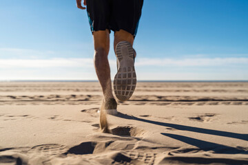 Man jogging at beach on sunny day