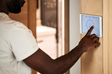 Man using home automation app on tablet PC