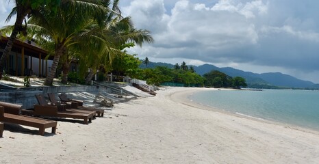 Sun beds next to a long beach in Langkawi, Malaysia