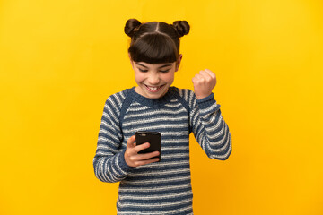 Little caucasian girl isolated on yellow background surprised and sending a message