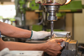 The machine operator working with NC milling machine.