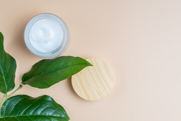 Top view of open glass jar with face cream. Skin care treatment with natural ingredients. Concept of natural cosmetics.