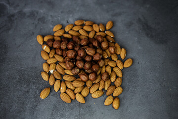 almonds and hazelnuts on dark background