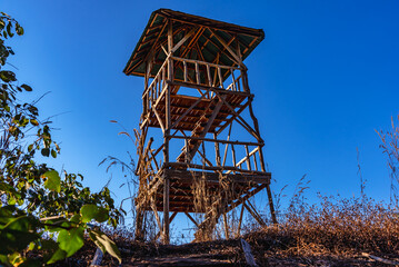 Fototapeta na wymiar Old wooden tower on the mountain forest