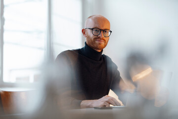 Smiling young businessman working in office