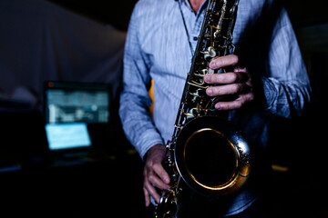 Saxophonist playing saxophone in recording studio