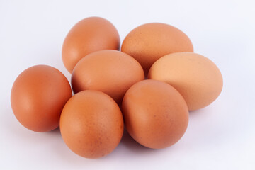seven eggs are placed on a white background with free space on right