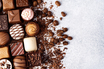 Chocolate candies and chocolate pieces pile for background