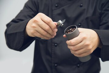 Asian barista is using hand coffee bean grinder prepare to make hot coffee