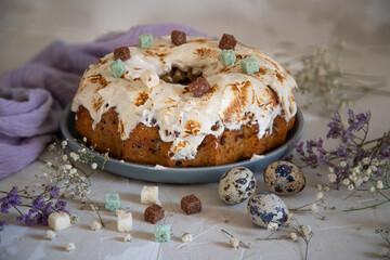Easter lemon cake with icing and easter decoration. Easter gugelhupf cake with coconut decorations, quail eggs