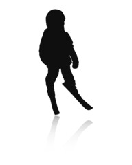 Fototapeta na wymiar Silhouette of a little boy who skis. The child in a helmet stands on skis.
