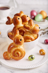 Easter bunny buns and colored eggs. Traditional Easter symbols and food.