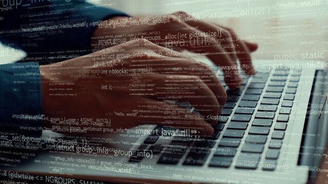 Computer programmer uses capable laptop computer to develop programming code of new software . Computer specialist working on future coding application for software programming development .