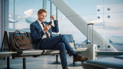 Airport Termina Flight Wait: Successful Businessman Uses Smartphone, Closes e-Business Deal and Celebrates Victory. Traveling Entrepreneur Remote Work Online in Boarding Lounge of Airline Hub