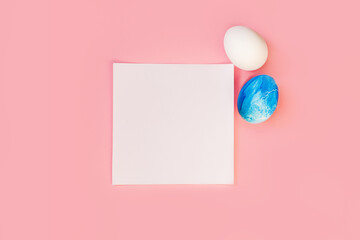 List or note isolated with set colorful eggs. Spring trendy composition on pastel pink background. Easter holiday concept. Flat lay, top view, place for text. Greeting card, notebook, frame, mock up