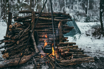 Old kettle in bushcraft wild camping. Snow camping.