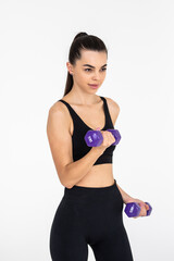Fototapeta premium Young woman with dumbbell fit slim abs body isolated on a white background. Healthy lifestyle.