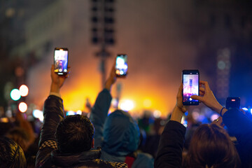 People with cell phones in their hands recording video of the Valencia traditional festival in March