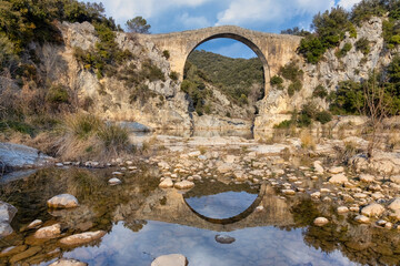 View of an ancient bridge Pont de Llierca in Catalonia, Spain.