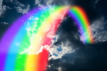 Colorful rainbow in clouds - beauty in nature concept.