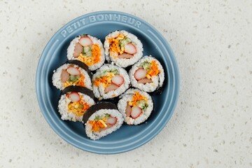 Gimbap or Kimbap, Korean Roll Rice with Nori Laver, Egg, Crab Stick, carrot, and Cucumber.