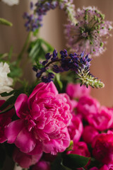 Beautiful floral background. Floral composition of fresh pink and white peonies as a decoration in the room.