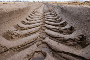 Footprint of wheel tread on the ground road. The trail from the tread of trucks wheels. Car tire...