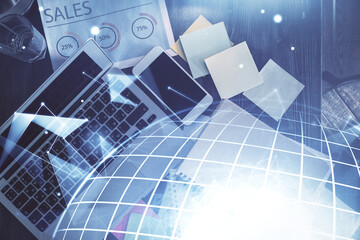 Double exposure of map hologram drawing over study table background with computer. Concept of international network. Top view.