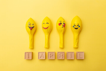 Creative minimalistic concept for April Fools' Day. wooden letters 1 april and festive decor on the...