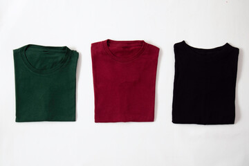 Folded black, dark red and green t-shirt with white background
