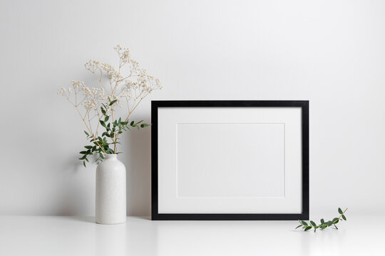Horizontal frame in white minimalistic interior with flowers decorations.