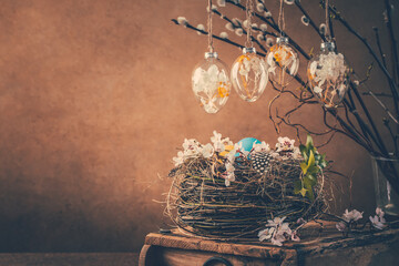 Nest with Easter eggs and blooming branches with pussy willow branches decorated