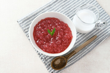 Bubur Mutiara, Bubur Sagu Mutiara, Indonesian Dessert Porridge. Made from pearl sago (sagu mutiara), sugar, pandan leaves, and coconut milk. Very famous during Ramadhan. Selective focus image.
