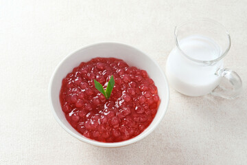 Bubur Mutiara, Bubur Sagu Mutiara, Indonesian Dessert Porridge. Made from pearl sago (sagu mutiara), sugar, pandan leaves, and coconut milk. Very famous during Ramadhan. Selective focus image.
