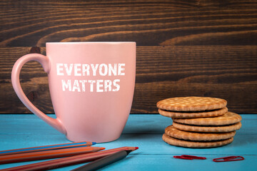 Everyone Matters. Coffee mug with text on the office desk