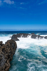 Fuerte oleaje entre rocas volcánicas
