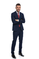 full body picture of elegant businessman crossing arms and smiling