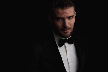 sexy man in his forties wearing tuxedo and being confident