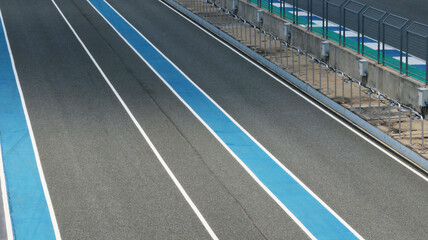 Asphalt race track with blue line background.	
