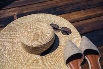 Fototapeta na wymiar Women's mules hat and sunglasses, set for vacation