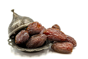 Date fruit isolated on a white background. Date fruits on a rustic serving plate