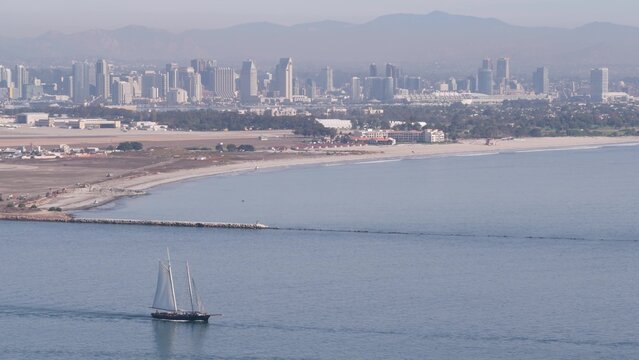 San Diego city skyline, cityscape of downtown with highrise skyscrapers, California coast, USA. View of Coronado island from above, Point Loma vista viewpoint. Frigate sail-powered ship, windjammer.