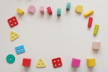 Top view colorful eco-friendly non-plastic wooden toys on white table. Early learning and development